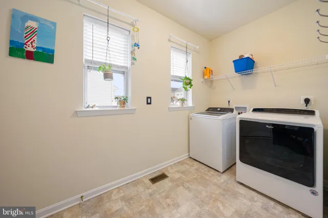 a living room with furniture and a large window with garden view