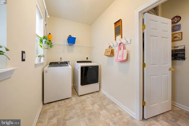 a spacious bedroom with a bed and a chandelier