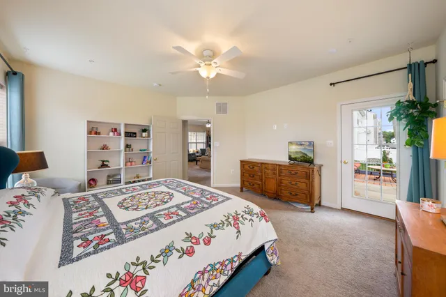 a bedroom with a bed a dresser and a shower