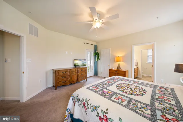 a bathroom with a double vanity sink a large mirror and shower