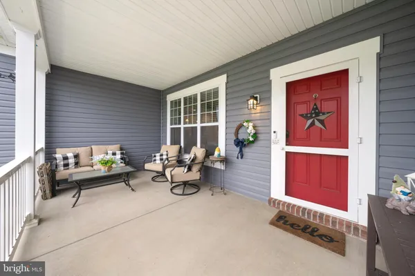 a large kitchen with kitchen island granite countertop a sink a counter top space and cabinets