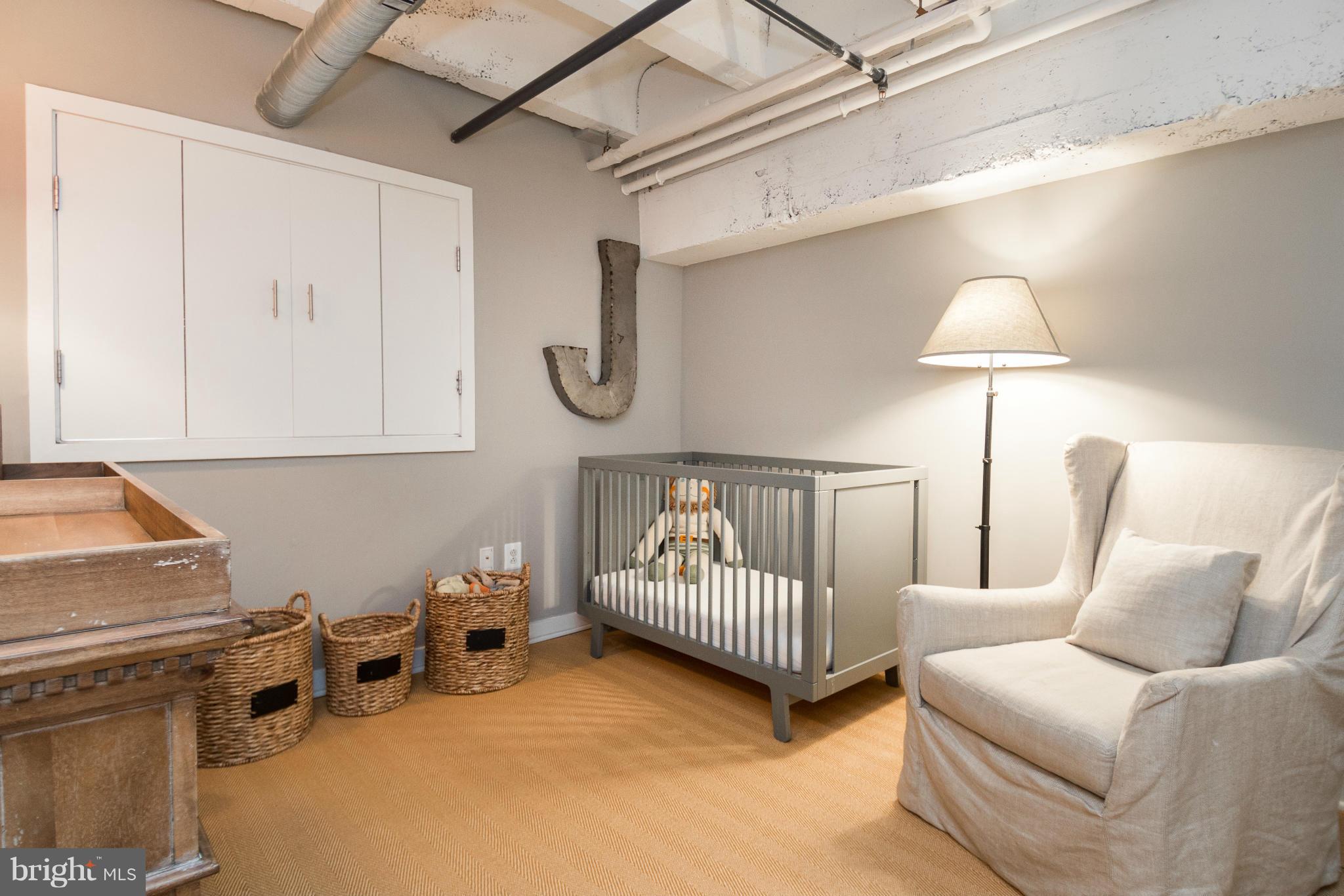 1401 Church Street Northwest, Unit 306 Washington, DC 20005 - Photo 16 of 18 a bed room with a bed and a chair