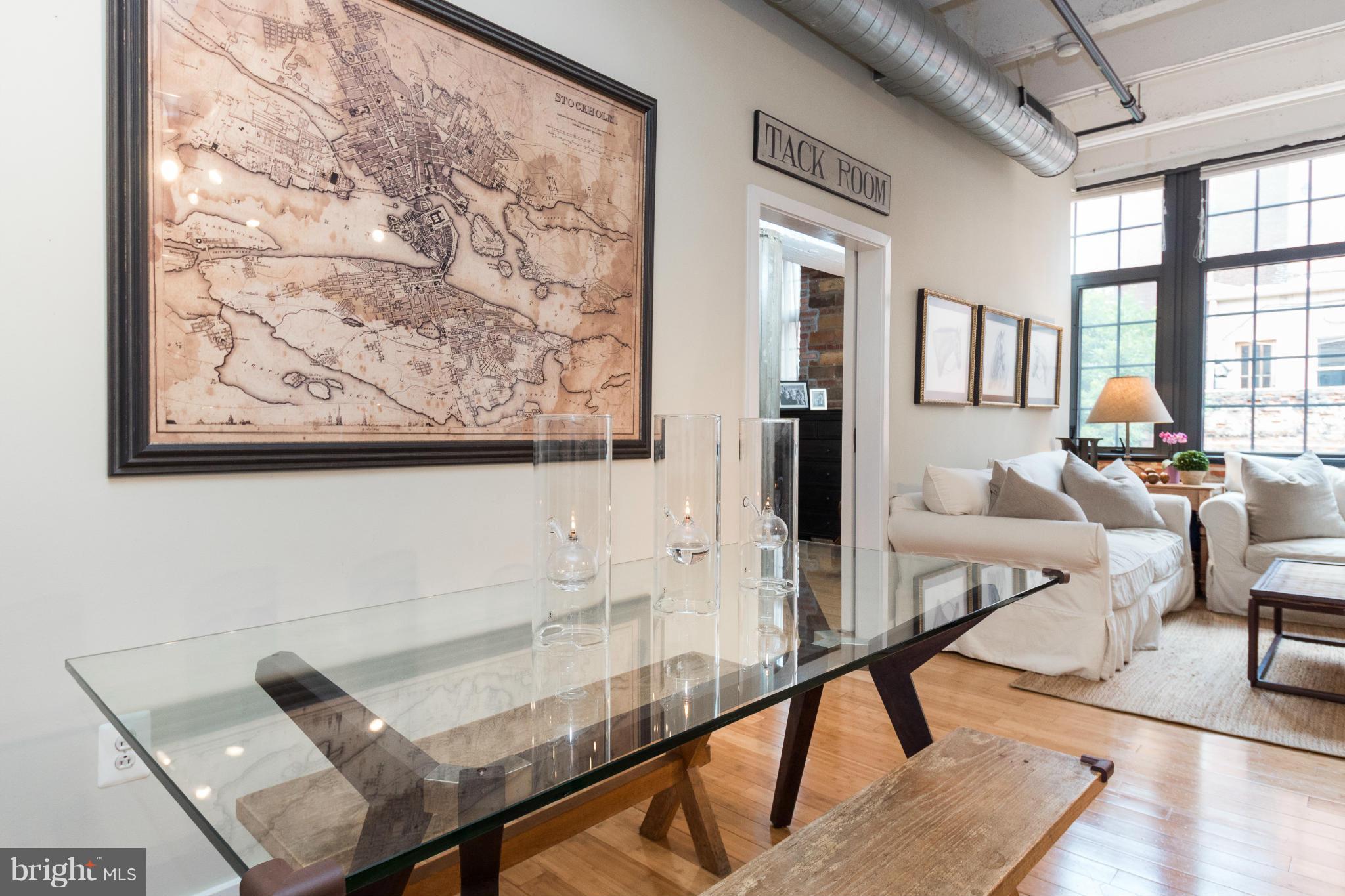 1401 Church Street Northwest, Unit 306 Washington, DC 20005 - Photo 5 of 18 a living room with furniture and floor to ceiling windows