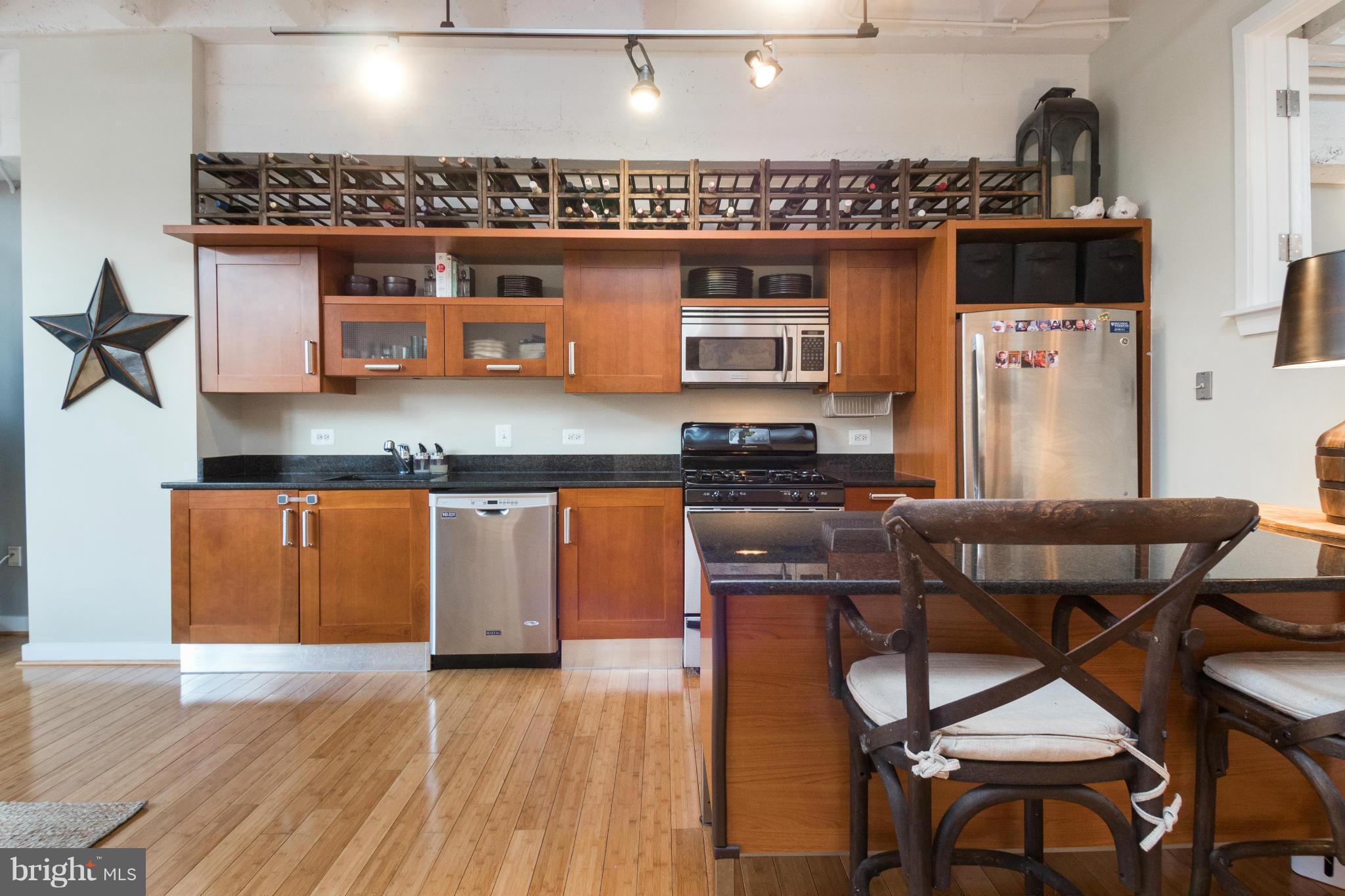1401 Church Street Northwest, Unit 306 Washington, DC 20005 - Photo 10 of 18 an open kitchen with a table and chairs
