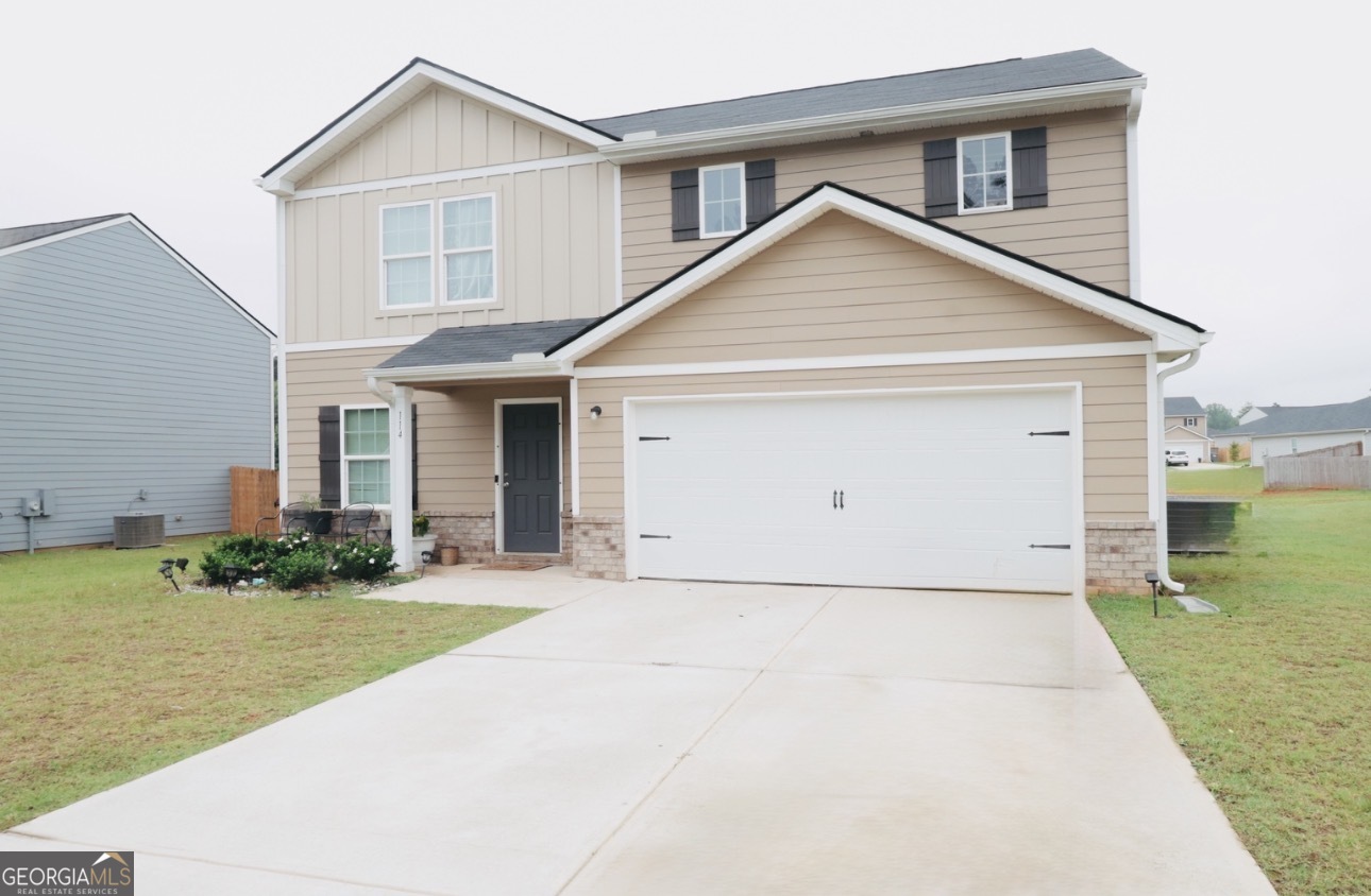 114 Catalpa Road Milner, GA 30257 - Photo 1 of 2 a view of a house with a yard and plants