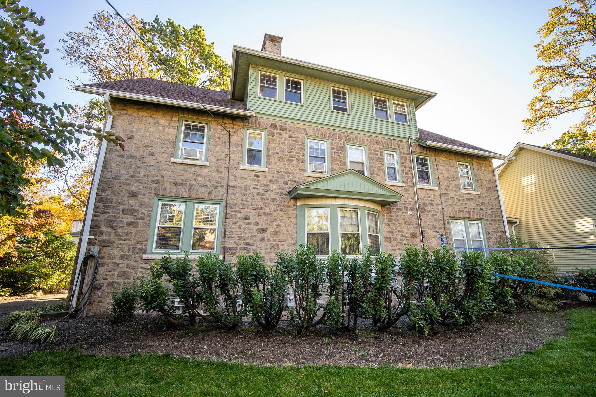 313 Edgewood Drive, Unit E Ambler, PA 19002 - Photo 3 of 9 a front view of a house with a yard