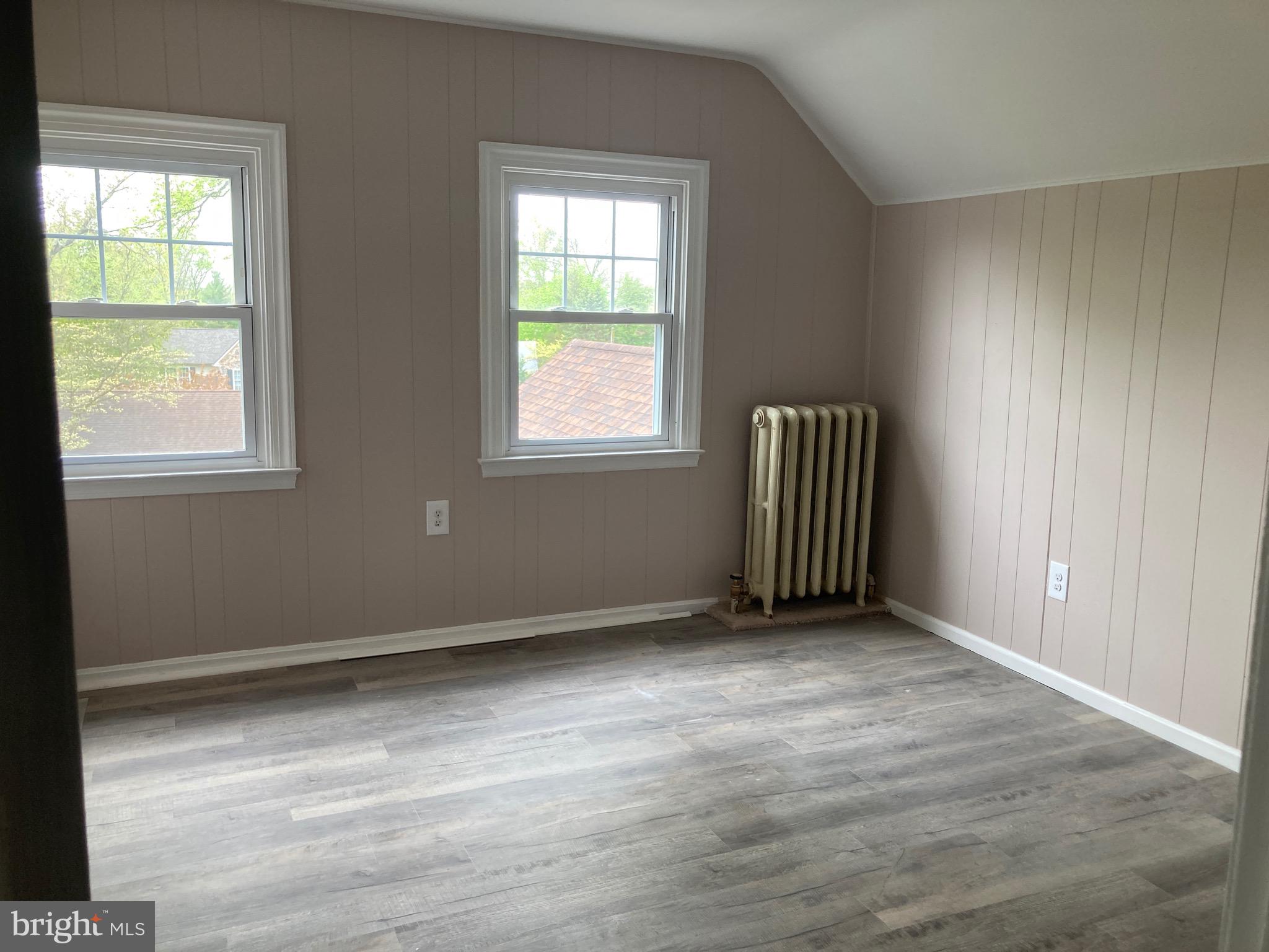 313 Edgewood Drive, Unit E Ambler, PA 19002 - Photo 9 of 9 an empty room with wooden floor and windows