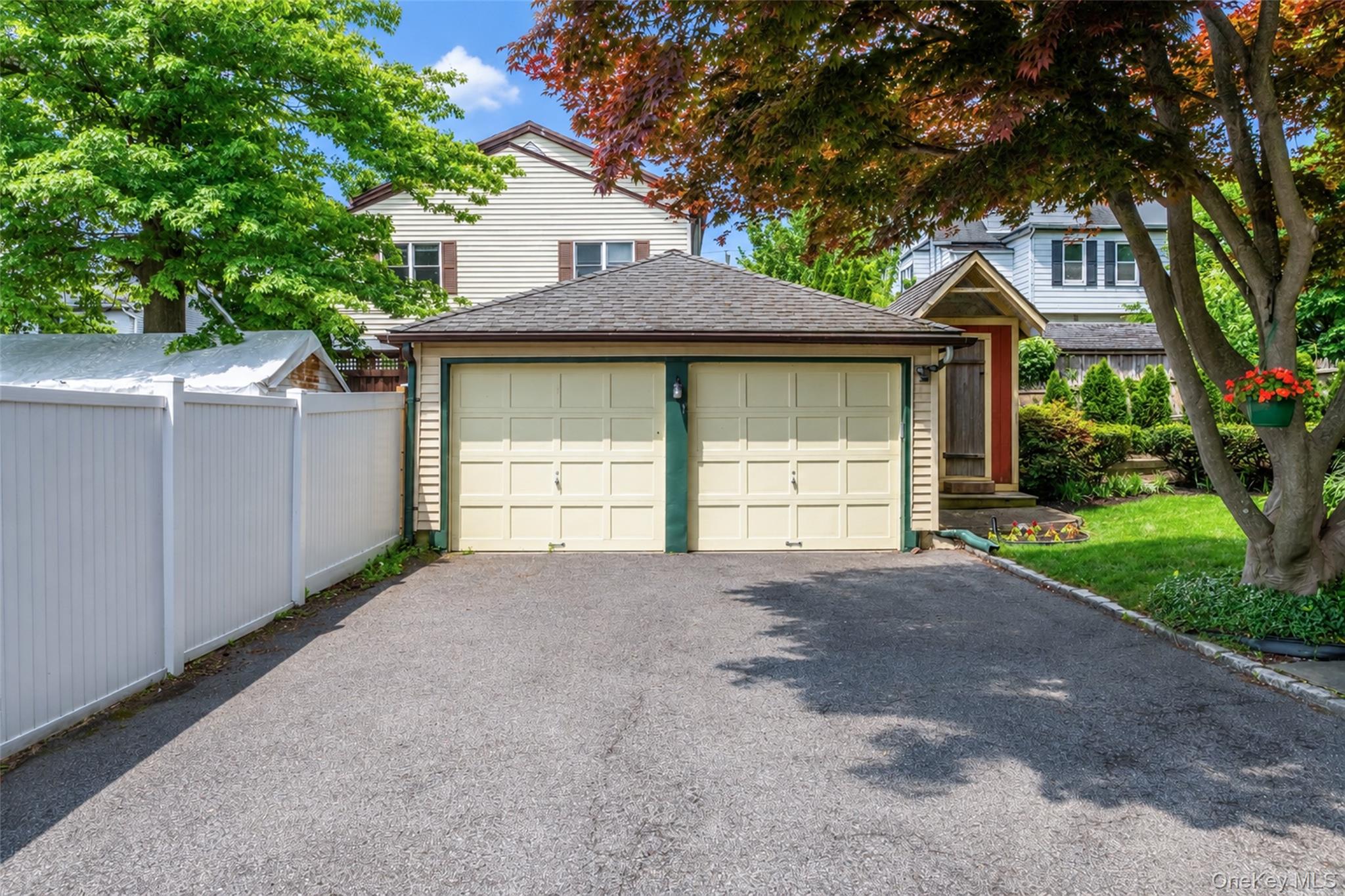 82 Clove Road New Rochelle, NY 10801 - Photo 38 of 39 a front view of a house with a yard and garage