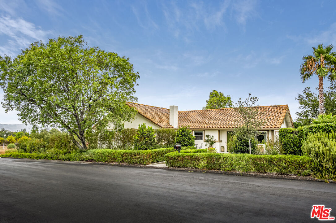 a front view of a house with a yard and a garage