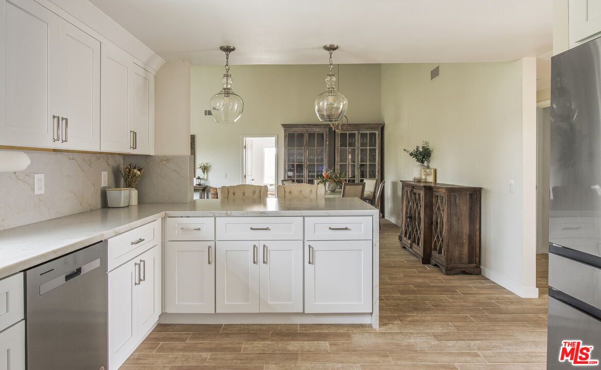 29720 Monte Verde Road Temecula, CA 92591 - Photo 11 of 49 a kitchen with white cabinets and refrigerator