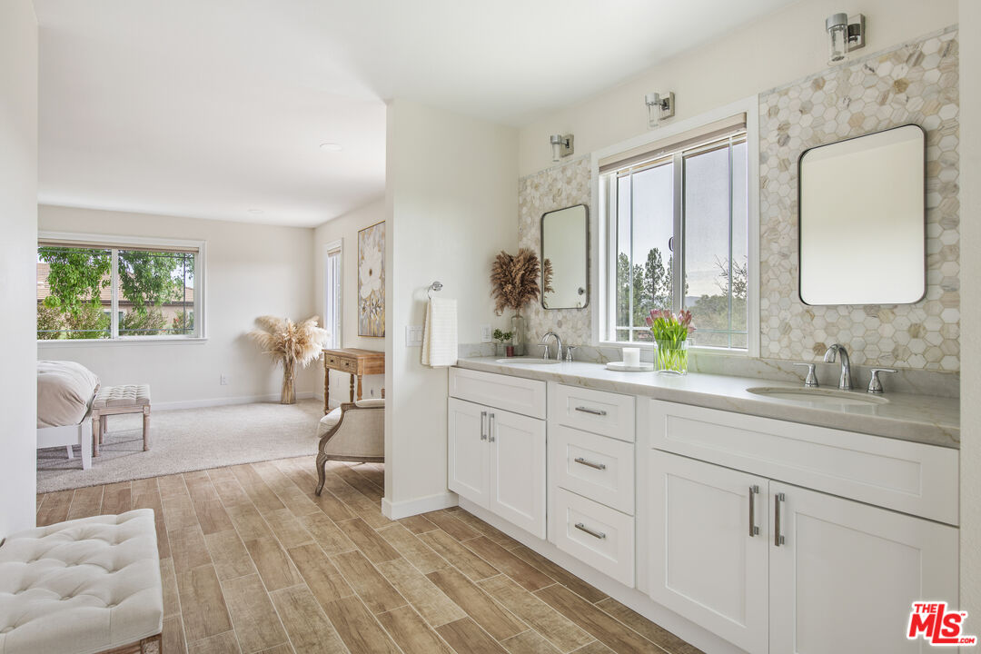 29720 Monte Verde Road Temecula, CA 92591 - Photo 18 of 49 a spacious bathroom with a double vanity sink a mirror and a window