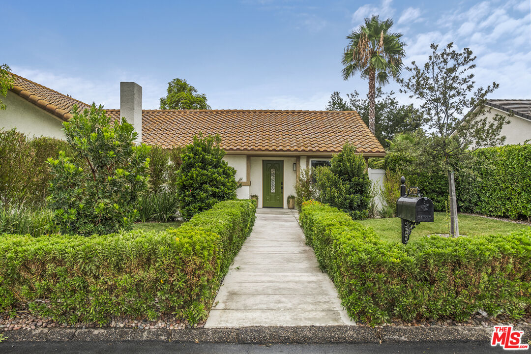 29720 Monte Verde Road Temecula, CA 92591 - Photo 2 of 49 a front view of a house with a yard and potted plants