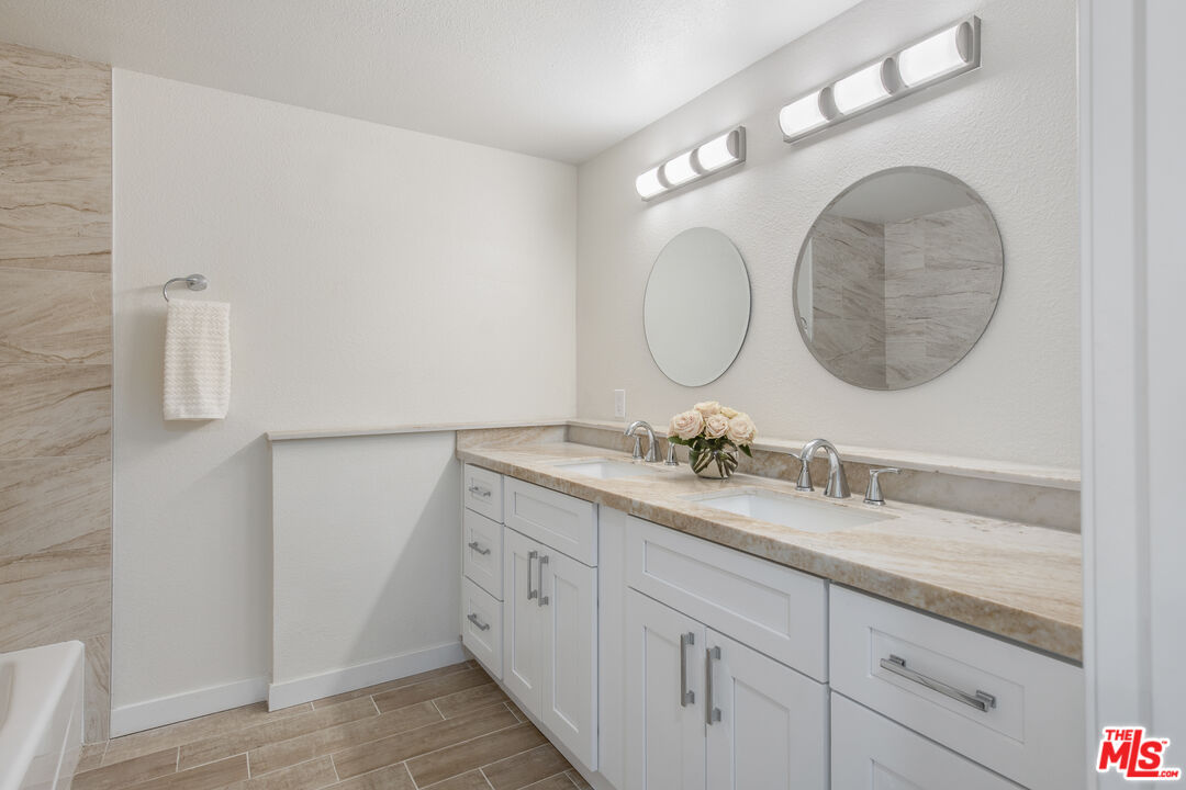 29720 Monte Verde Road Temecula, CA 92591 - Photo 30 of 49 a bathroom with a granite countertop double vanity sink and a mirror