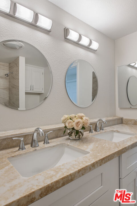 29720 Monte Verde Road Temecula, CA 92591 - Photo 32 of 49 a bathroom with a granite countertop sink and a mirror