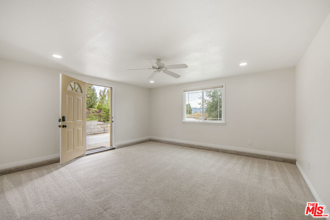 29720 Monte Verde Road Temecula, CA 92591 - Photo 33 of 49 an empty room with windows and a ceiling fan