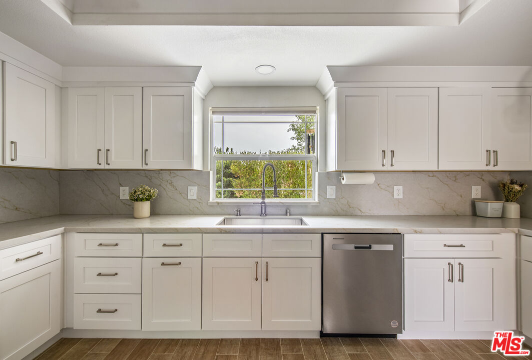 29720 Monte Verde Road Temecula, CA 92591 - Photo 8 of 49 a kitchen with white cabinets and sink