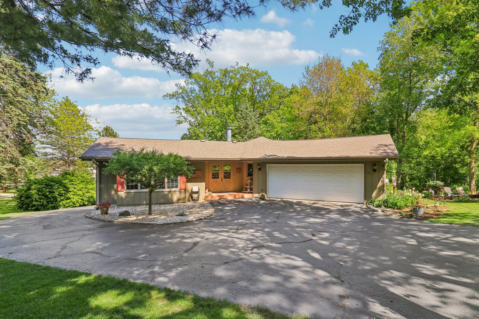 554 Baintree Road Davis, IL 61019 - Photo 1 of 53 a backyard of a house with table and chairs under an umbrella