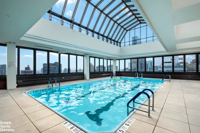 a view of swimming pool with a bench in patio