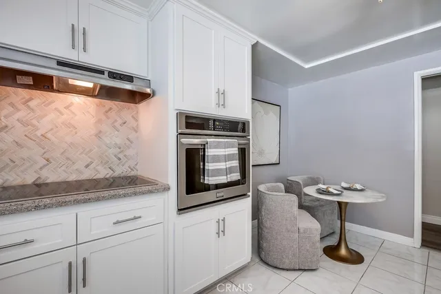 a kitchen with stainless steel appliances white cabinets and a granite counter tops