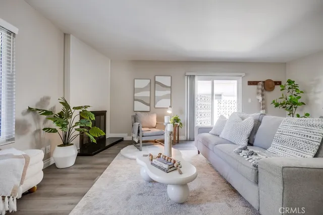 a living room with furniture and a potted plant