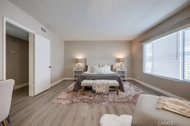 a bedroom with a bed and wooden floor