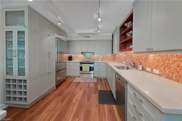 a kitchen with stainless steel appliances a sink and a stove