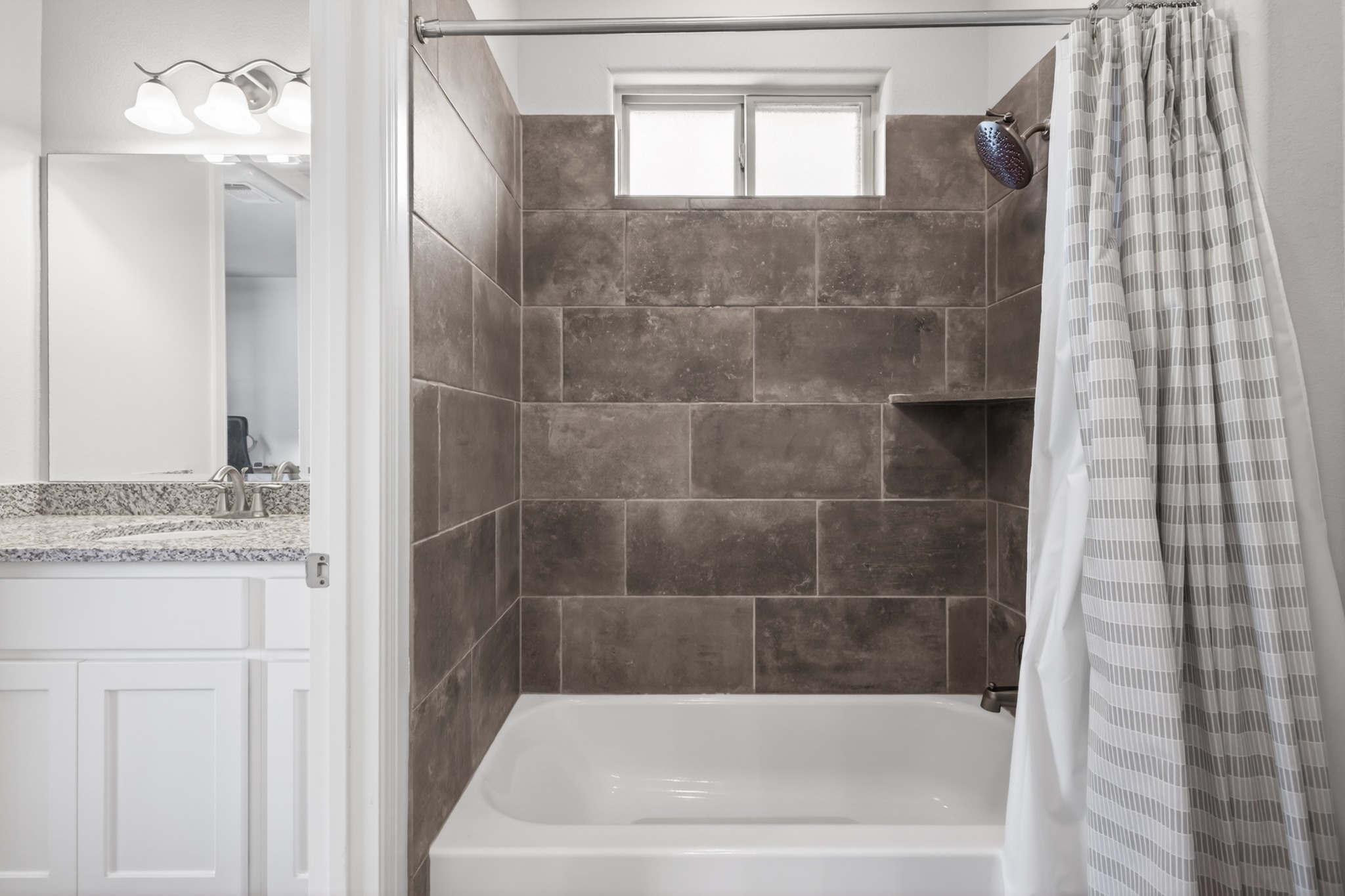 4105 Haight Street Round Rock, TX 78681 - Photo 29 of 40 a bathroom with a granite countertop bathtub shower and vanity