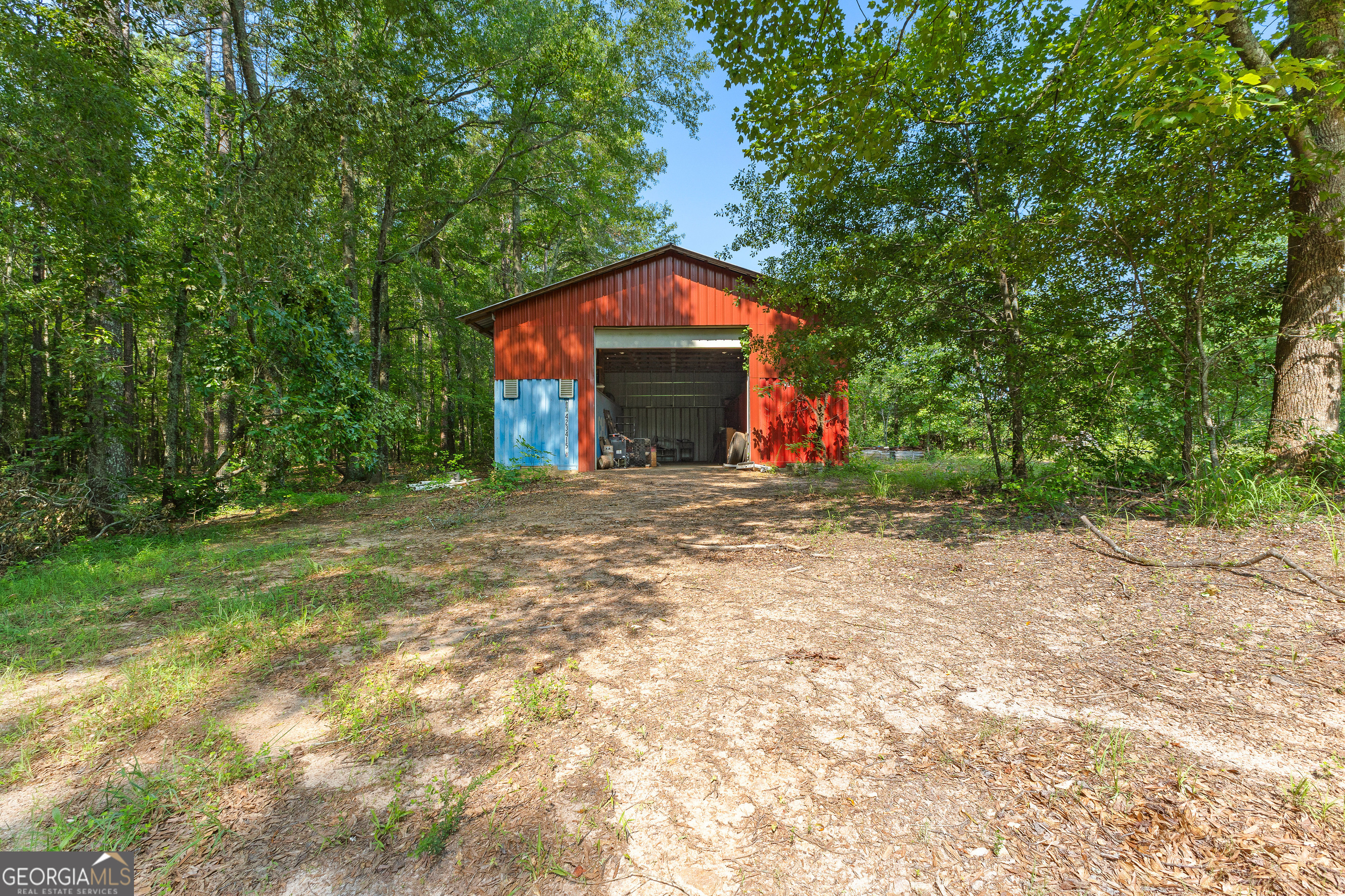 6536 Luthersville Road Gay, GA 30218 - Photo 80 of 93 a view of a house with a small yard and large trees
