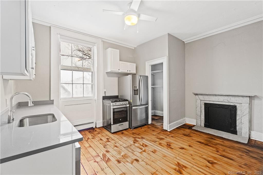 a kitchen with a stove sink and a refrigerator