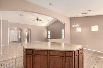 10344 West Trumbull Road Tolleson, AZ 85353 - Photo 14 of 22 a view with kitchen island a sink and a refrigerator
