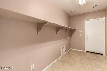 a view of a refrigerator in an empty room