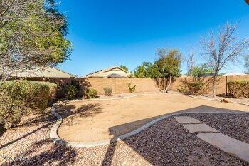 10344 West Trumbull Road Tolleson, AZ 85353 - Photo 22 of 22 a view of a yard with wooden fence