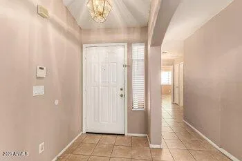 a view of a hallway to rooms