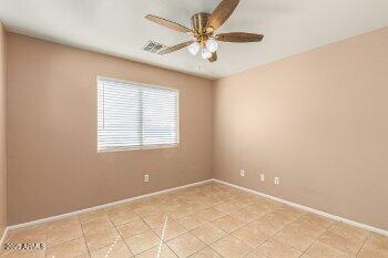10344 West Trumbull Road Tolleson, AZ 85353 - Photo 10 of 22 an empty room with a chandelier fan and windows