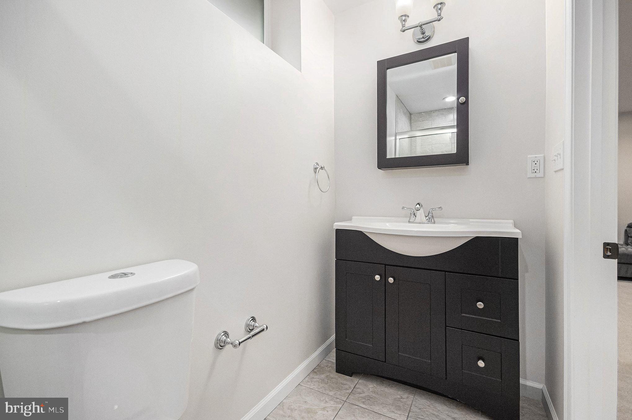 1309 Rock Chapel Road Herndon, VA 20170 - Photo 17 of 41 a bathroom with a sink vanity and mirror