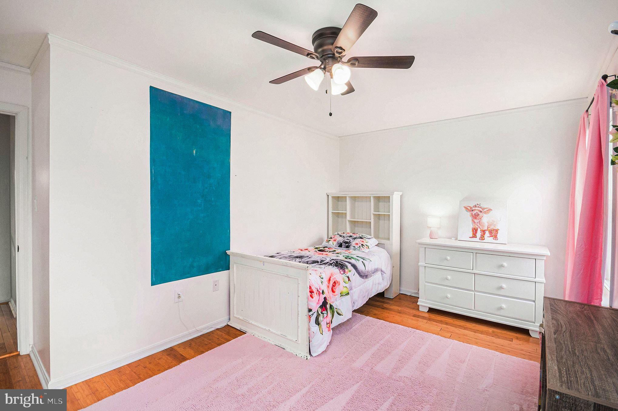 1309 Rock Chapel Road Herndon, VA 20170 - Photo 23 of 41 a bedroom with a bed and a chandelier