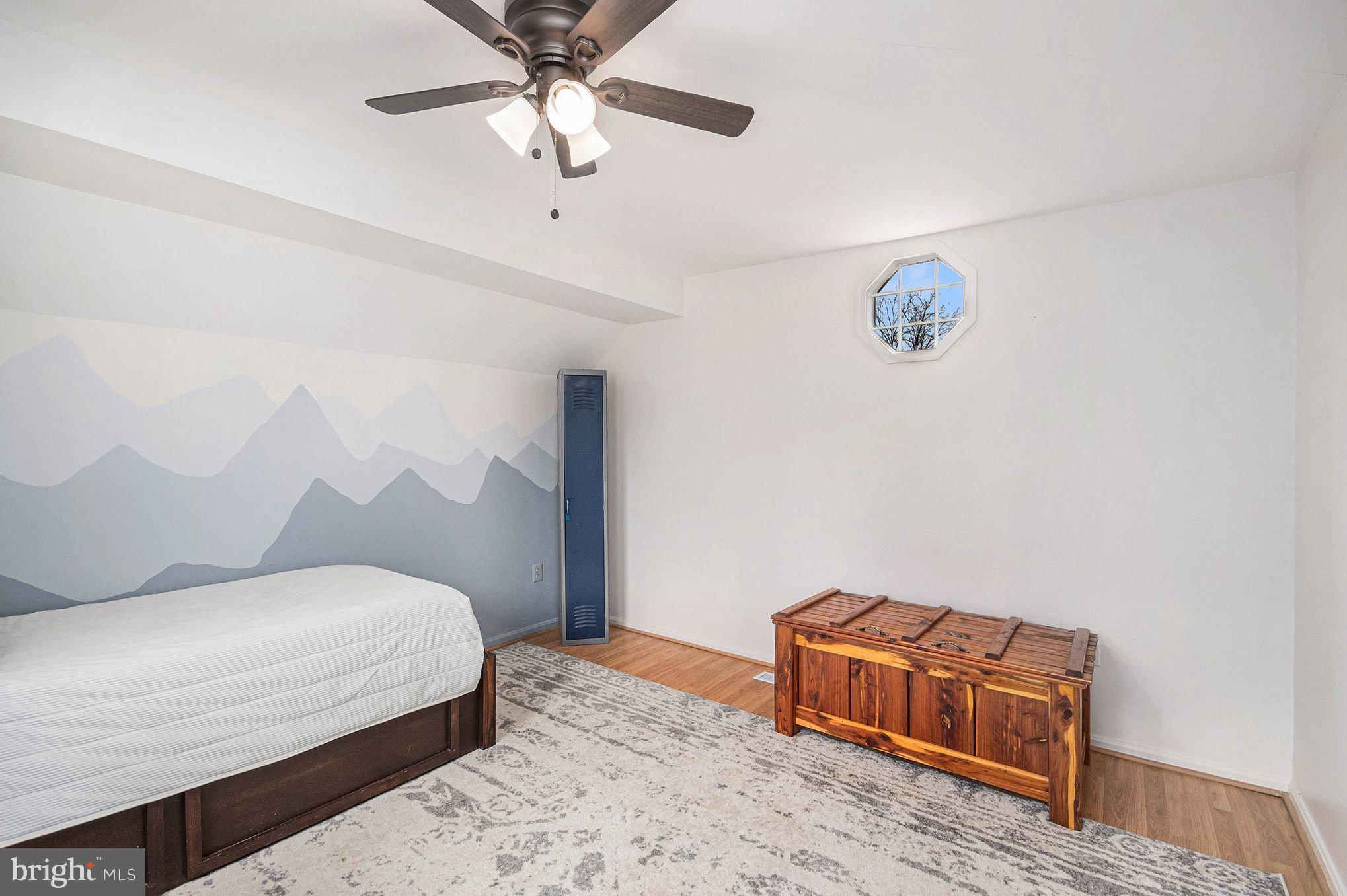 1309 Rock Chapel Road Herndon, VA 20170 - Photo 25 of 41 a bedroom with a bed and a chandelier