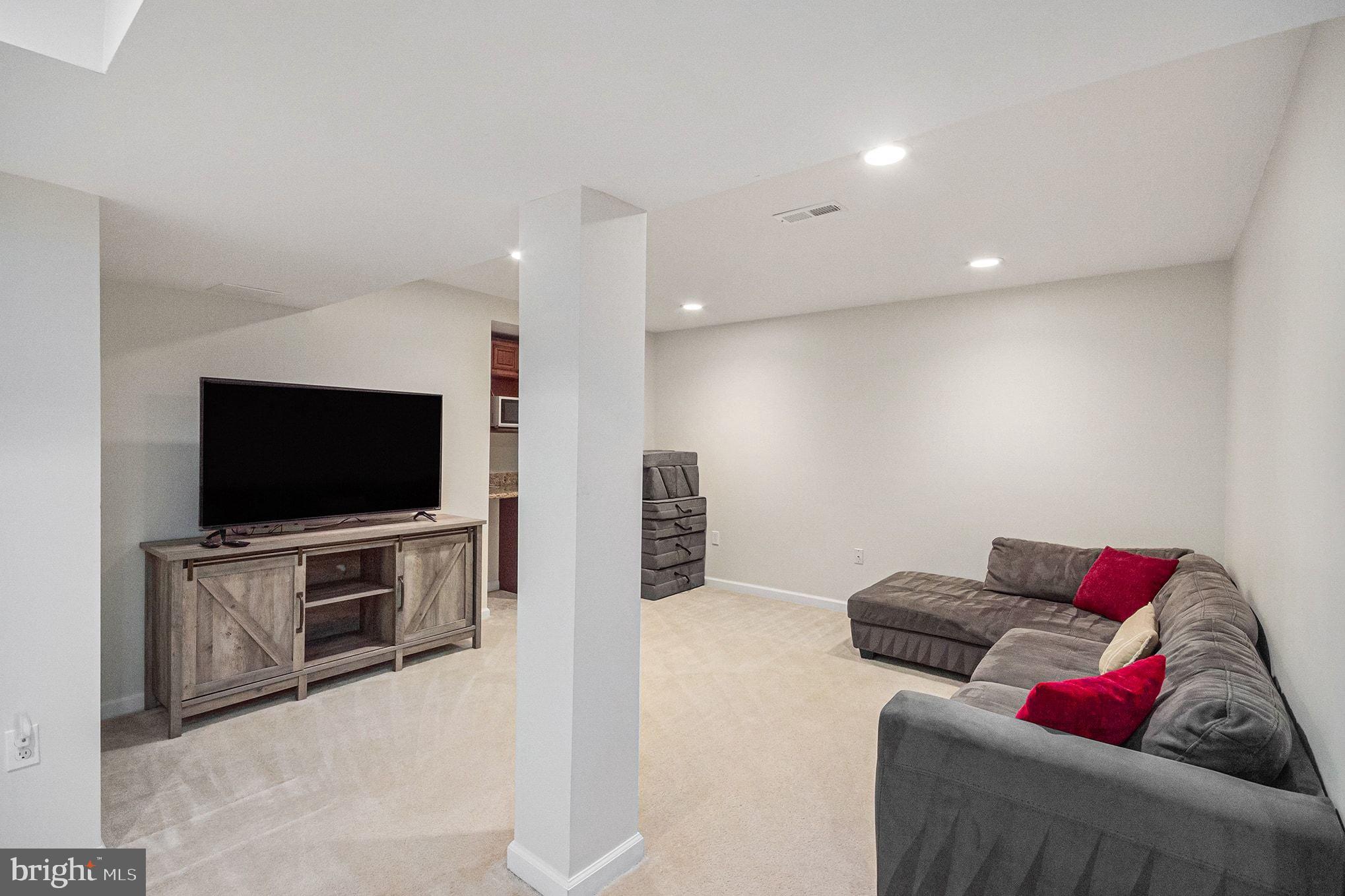 1309 Rock Chapel Road Herndon, VA 20170 - Photo 28 of 41 a living room with furniture and a flat screen tv