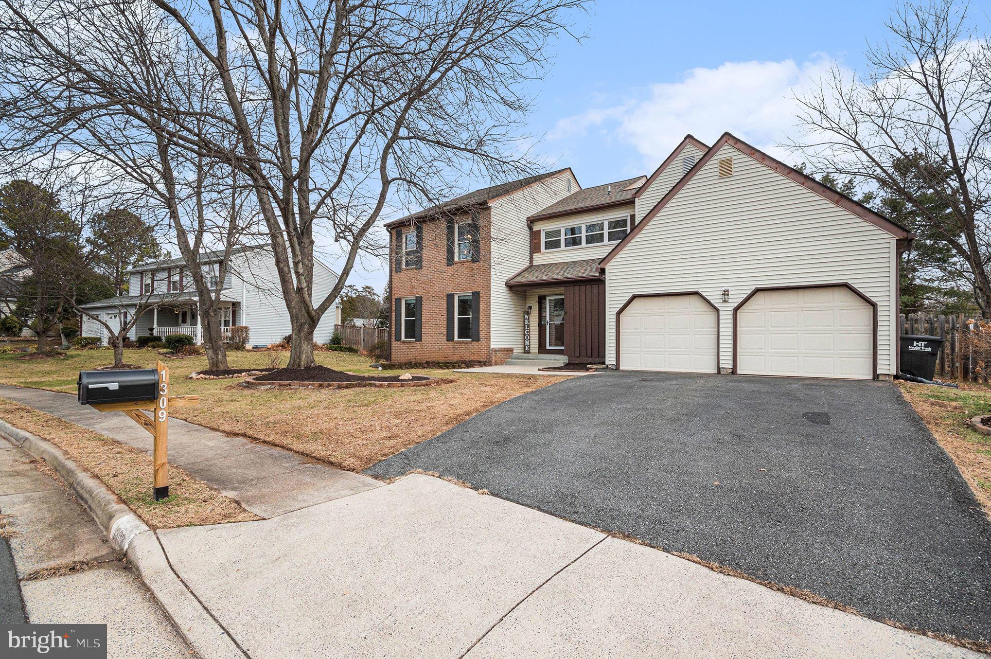 1309 Rock Chapel Road Herndon, VA 20170 - Photo 40 of 41 a view of a white house with a yard and large tree