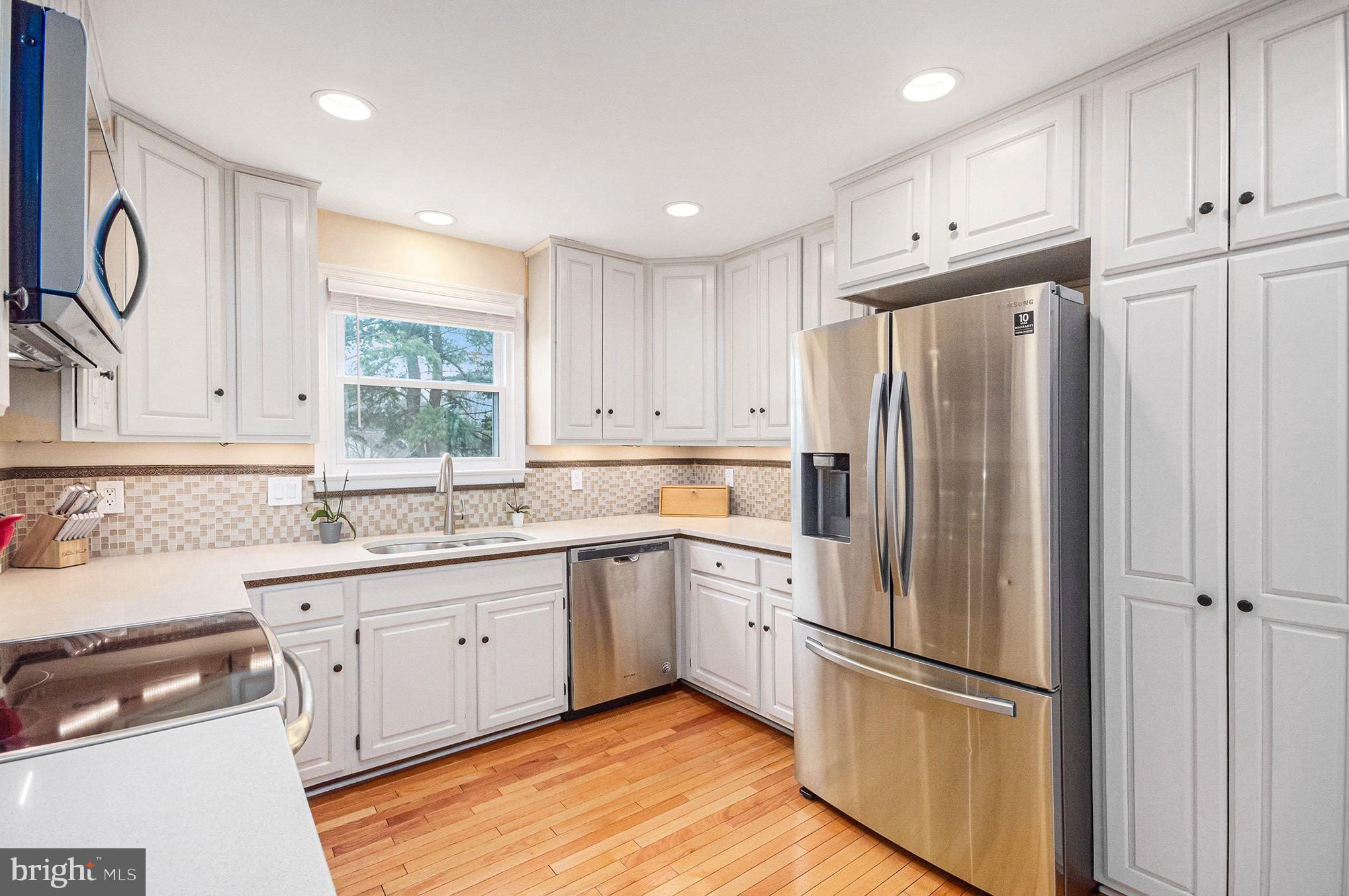 1309 Rock Chapel Road Herndon, VA 20170 - Photo 10 of 41 a kitchen with a refrigerator a sink and cabinets