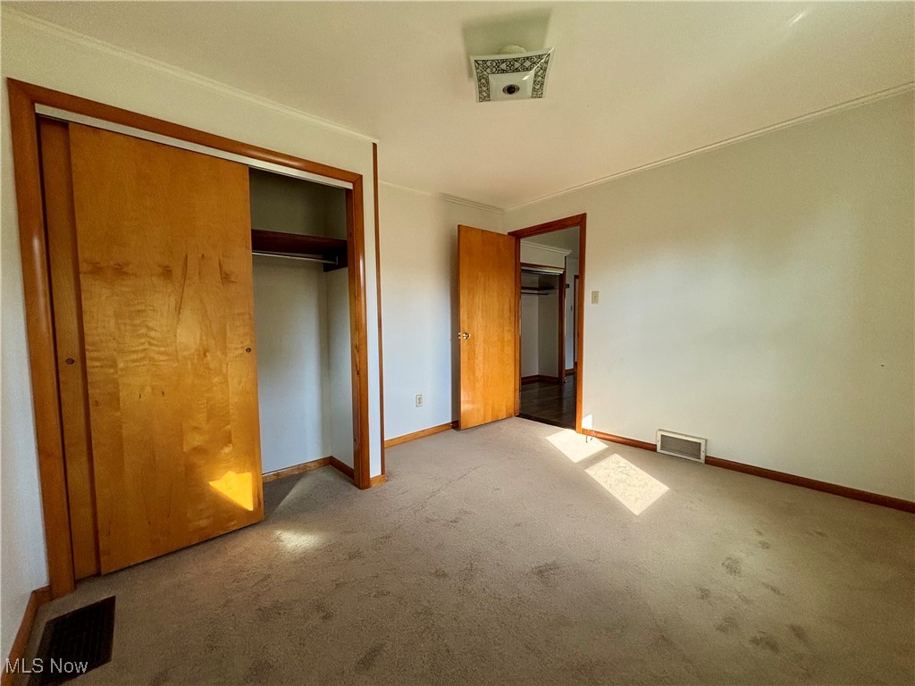 164 Locust Lane Follansbee, WV 26037 - Photo 9 of 19 Unfurnished bedroom featuring carpet, a closet, and crown molding