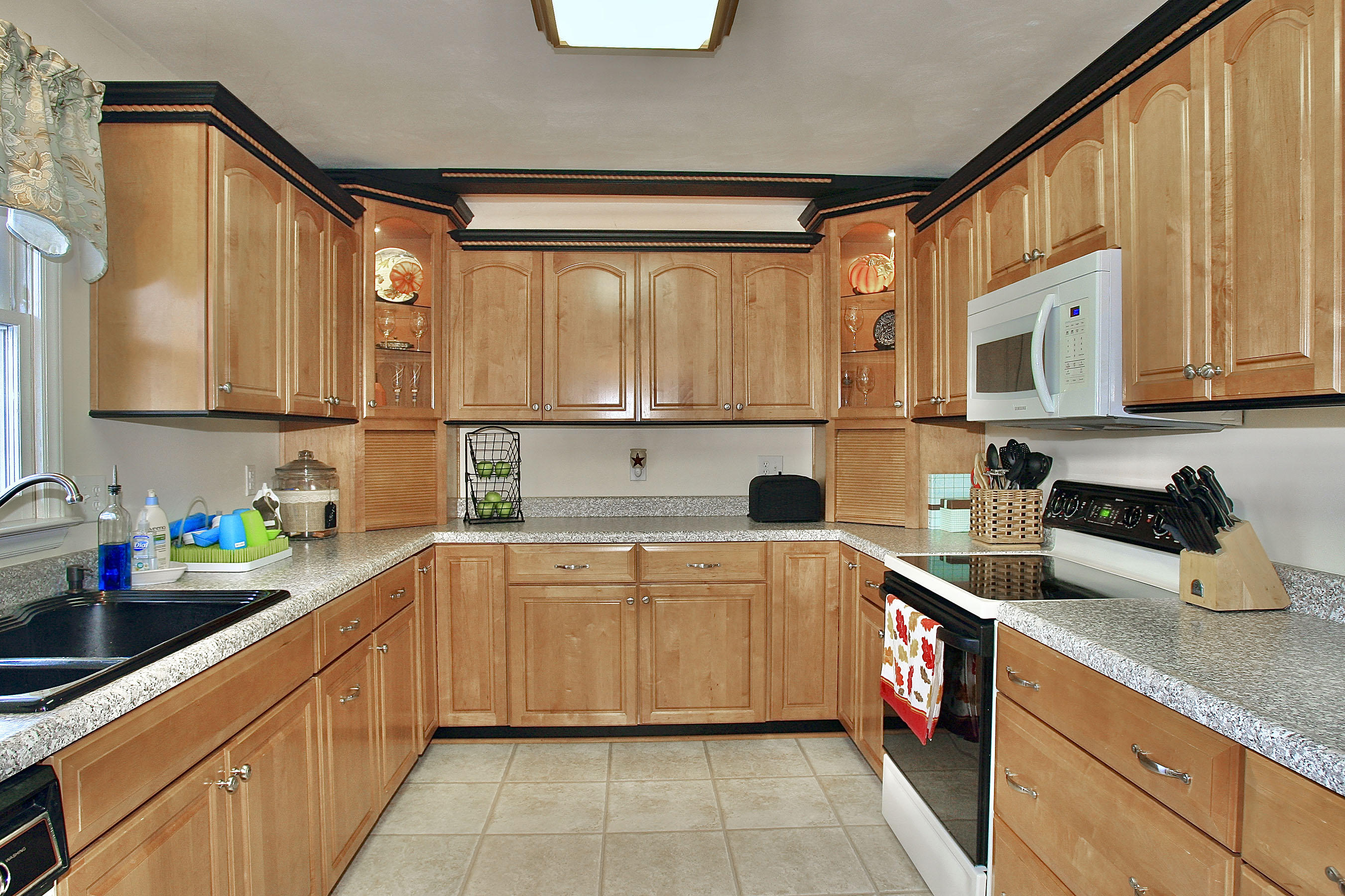 1025 Rock Spring Road Goodview, VA 24095 - Photo 14 of 73 a kitchen with stainless steel appliances a sink dishwasher stove refrigerator and cabinets with wooden floor