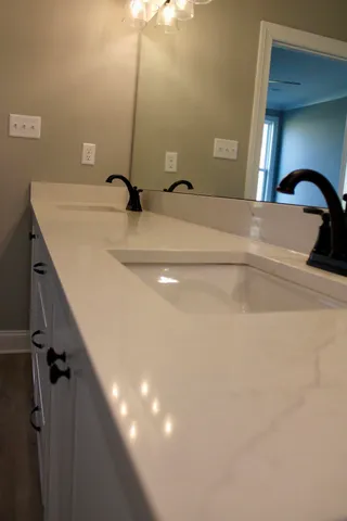 a bathroom with a sink and mirror