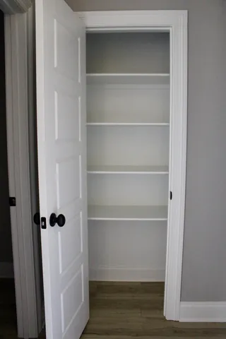 a view of white cabinets and a refrigerator