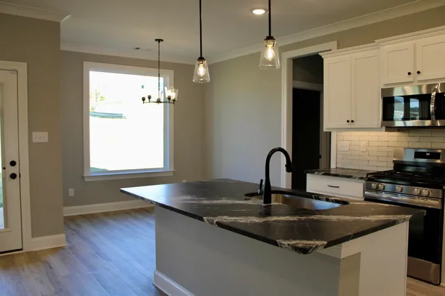 a kitchen with sink refrigerator and stove