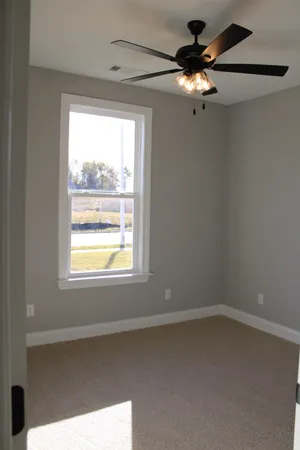 a view of a livingroom with a ceiling fan and window