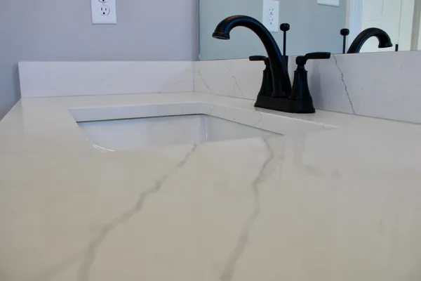 a close view of a sink and a shower