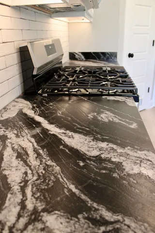 a close up of a stove top oven sitting on a floor