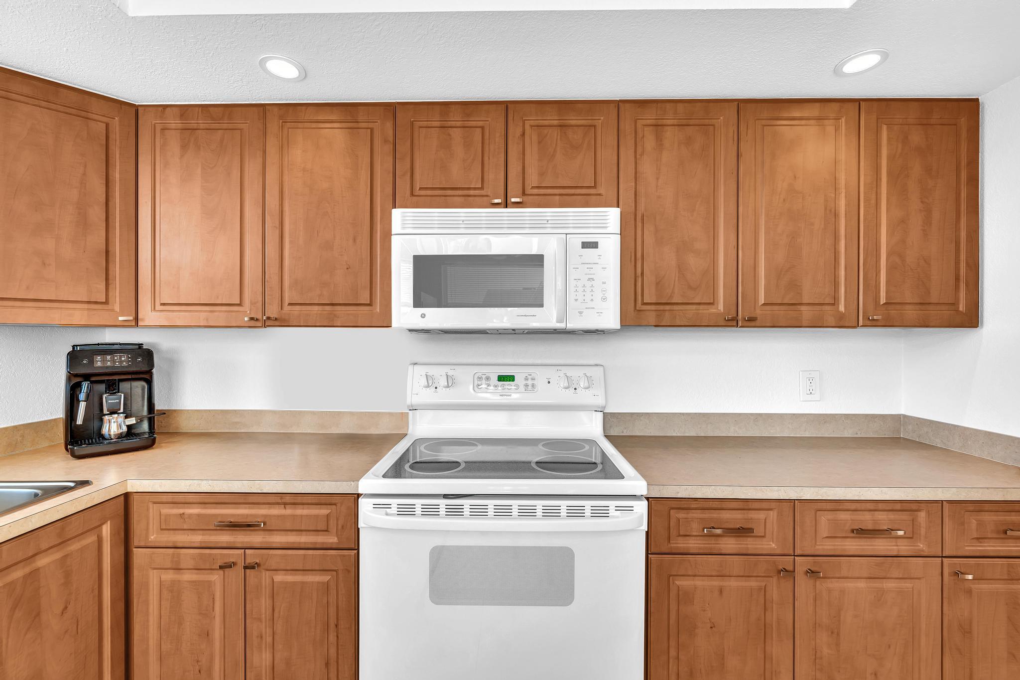 3 Colonial Club Drive, Unit 300 Boynton Beach, FL 33435 - Photo 13 of 71 a kitchen with a stove and a microwave