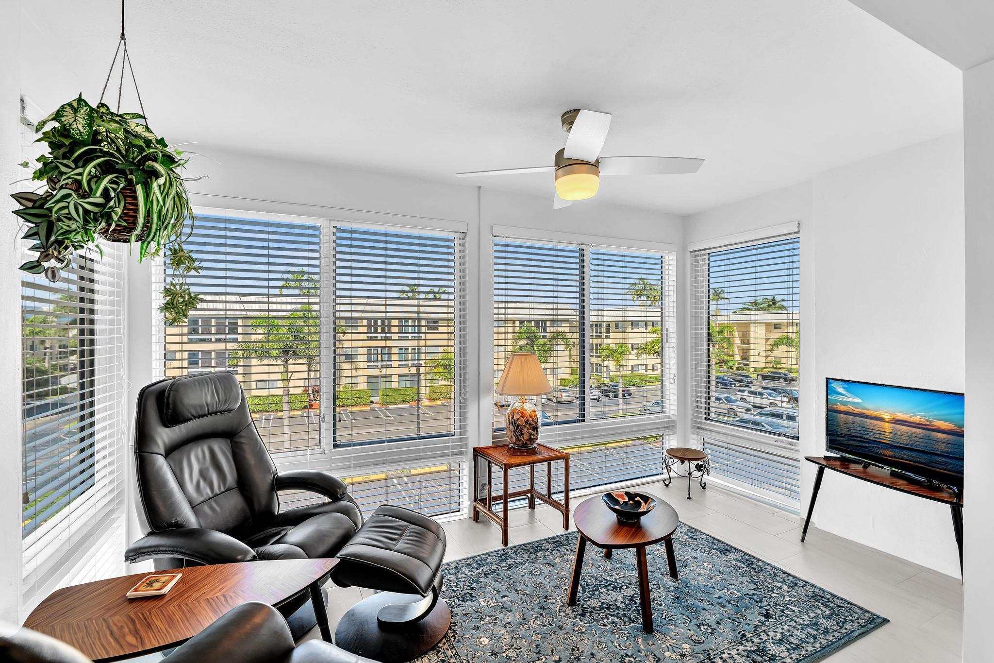 3 Colonial Club Drive, Unit 300 Boynton Beach, FL 33435 - Photo 15 of 71 a living room with furniture and floor to ceiling windows